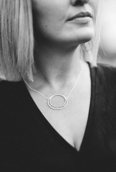 brass circle and silver necklace